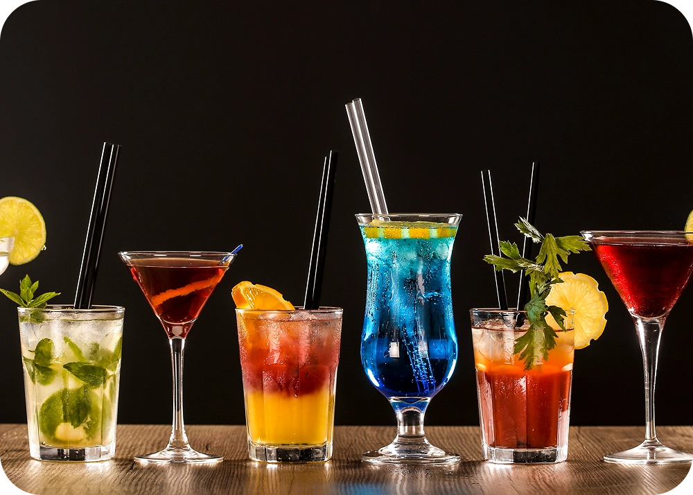 Assorted vibrant drinks with garnishes and straws