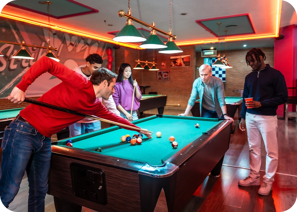 Group having fun around a pool table